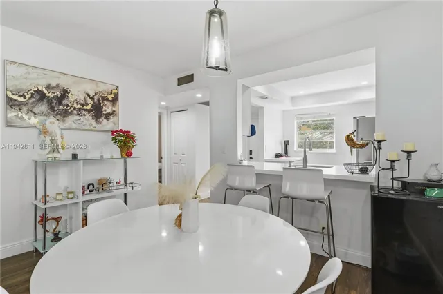 a large white kitchen with a large island in it