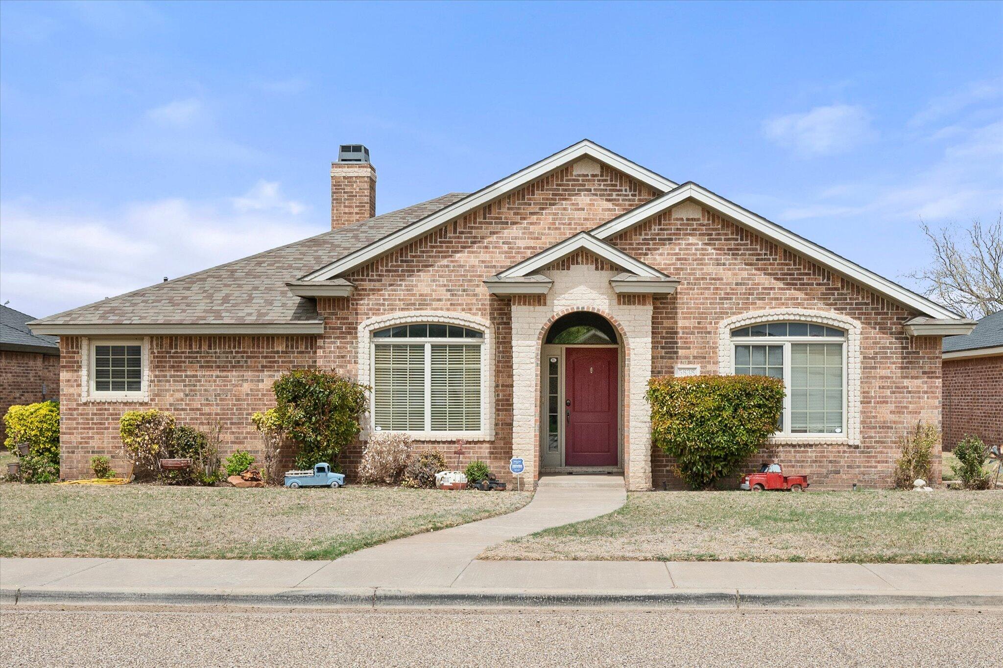 5838 101st Street Lubbock, TX 79424 - Photo 1 of 37 a front view of a house with a yard and garage