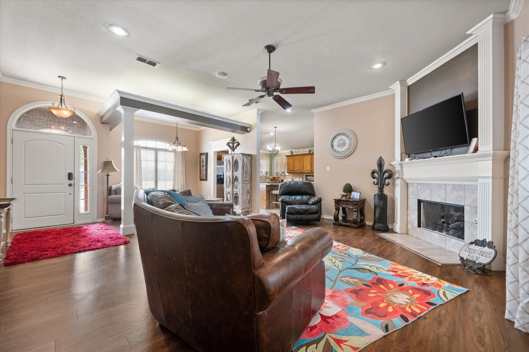 5838 101st Street Lubbock, TX 79424 - Photo 16 of 37 a living room with fireplace furniture and a flat screen tv