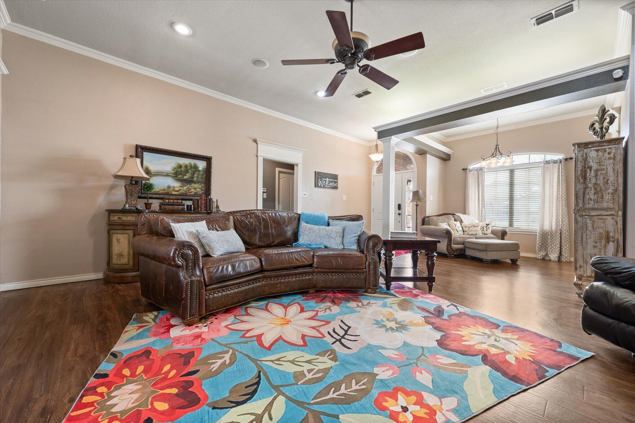 5838 101st Street Lubbock, TX 79424 - Photo 17 of 37 a living room with furniture and a wooden floor