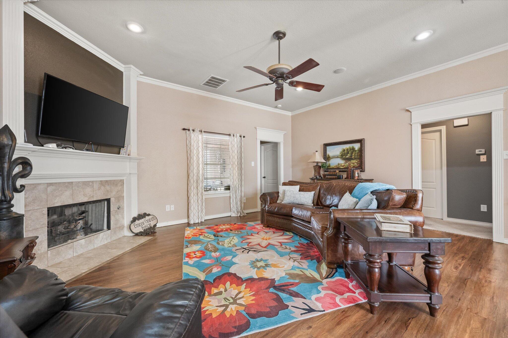 5838 101st Street Lubbock, TX 79424 - Photo 18 of 37 a living room with furniture fireplace and flat screen tv