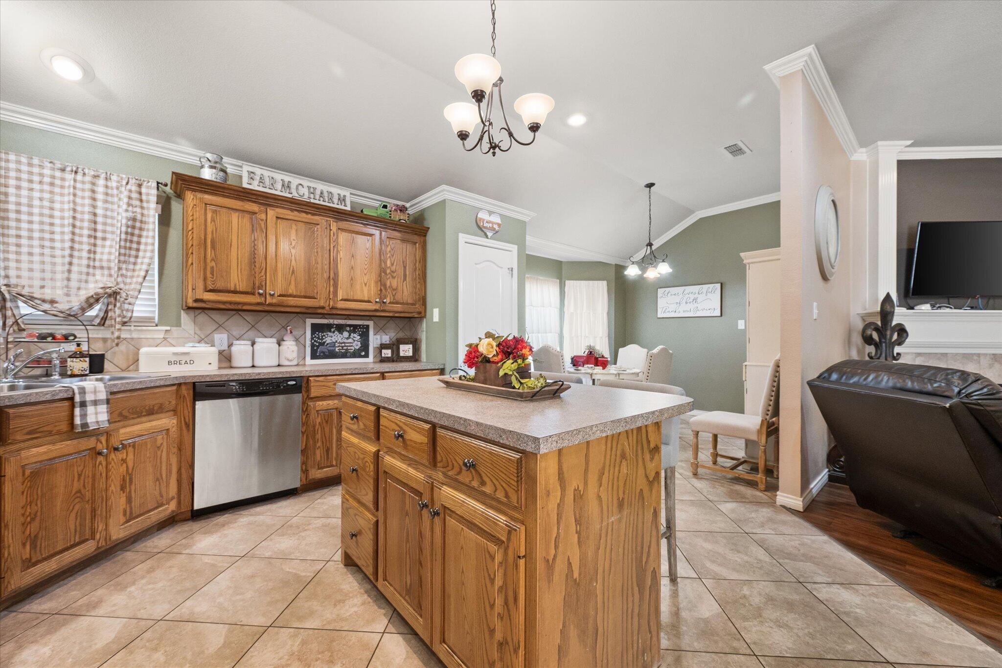 5838 101st Street Lubbock, TX 79424 - Photo 20 of 37 a kitchen with stainless steel appliances granite countertop a stove cabinets a sink and a refrigerator