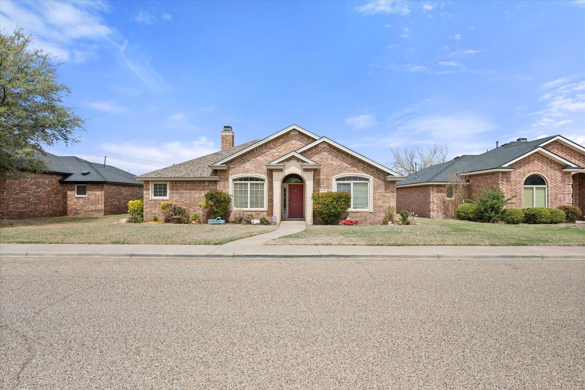 5838 101st Street Lubbock, TX 79424 - Photo 2 of 37 a front view of a house with a yard and garage