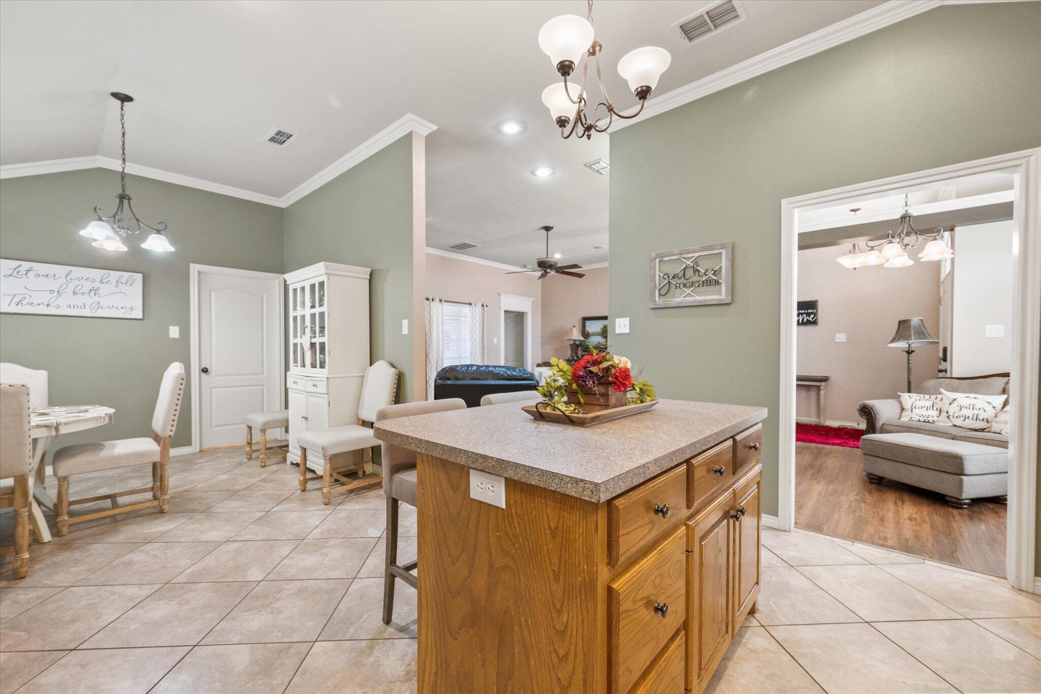 5838 101st Street Lubbock, TX 79424 - Photo 23 of 37 a view of kitchen center island and living room