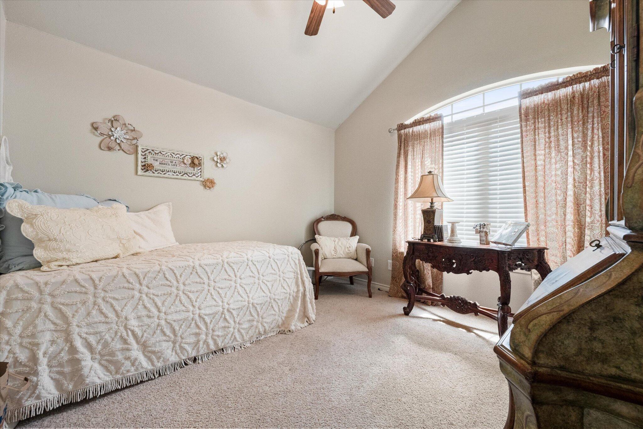 5838 101st Street Lubbock, TX 79424 - Photo 27 of 37 a bedroom with a bed and a couch