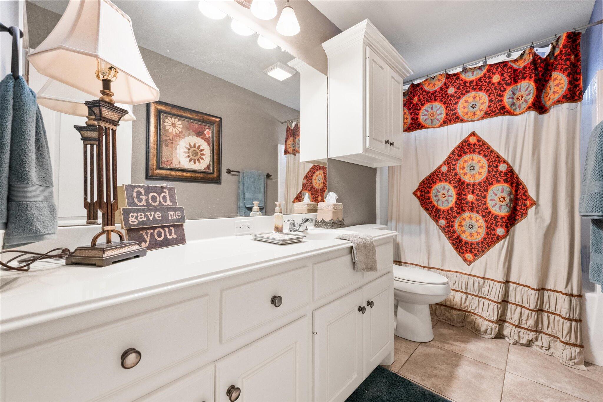 5838 101st Street Lubbock, TX 79424 - Photo 28 of 37 a bathroom with a sink mirror and vanity