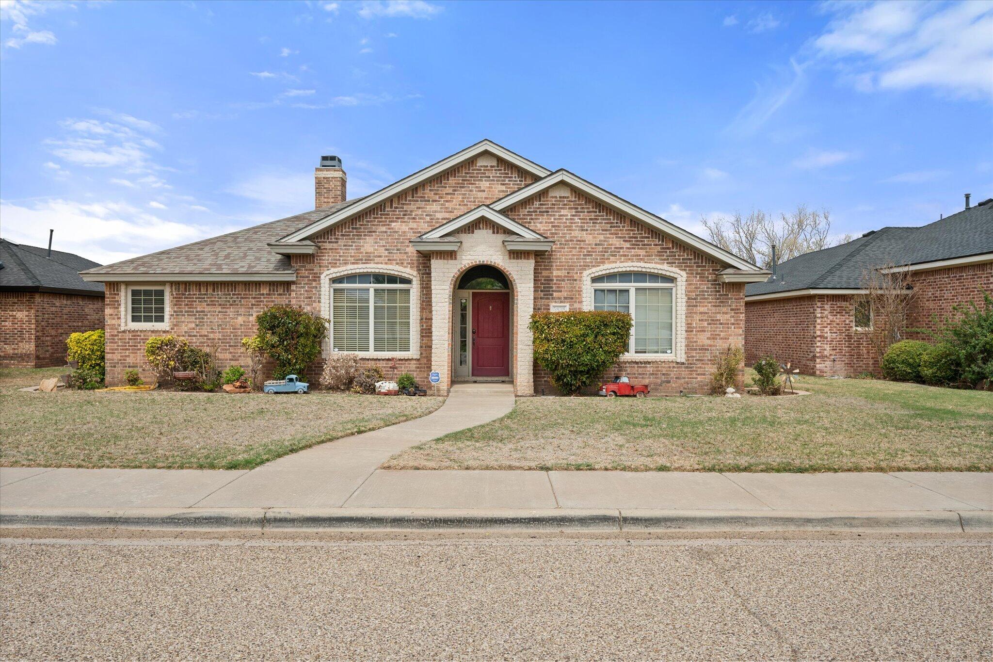 5838 101st Street Lubbock, TX 79424 - Photo 3 of 37 a front view of a house with a yard and garage