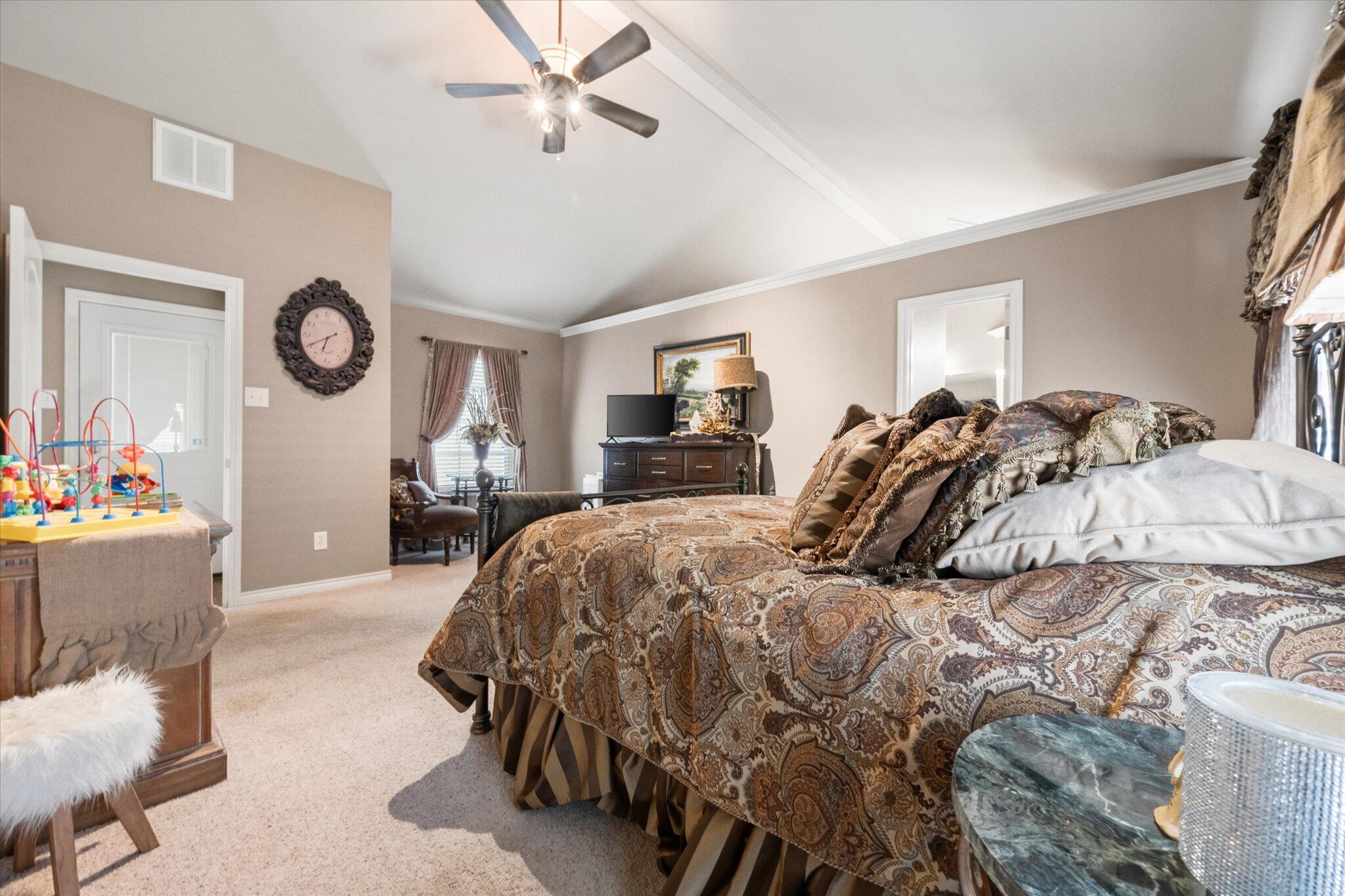 5838 101st Street Lubbock, TX 79424 - Photo 31 of 37 a bed sitting in a bedroom next to a window with pc on the wall