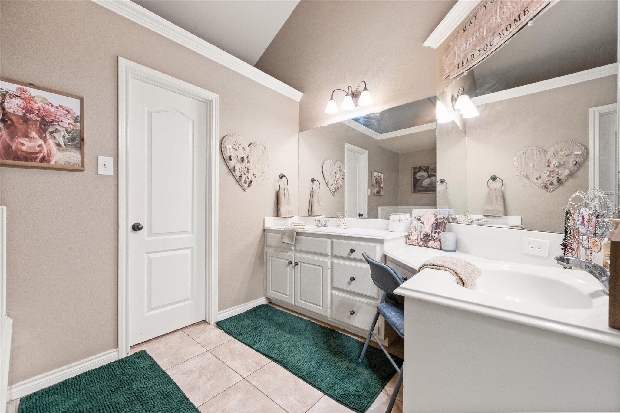 5838 101st Street Lubbock, TX 79424 - Photo 32 of 37 a spacious bathroom with a sink a vanity and a mirror