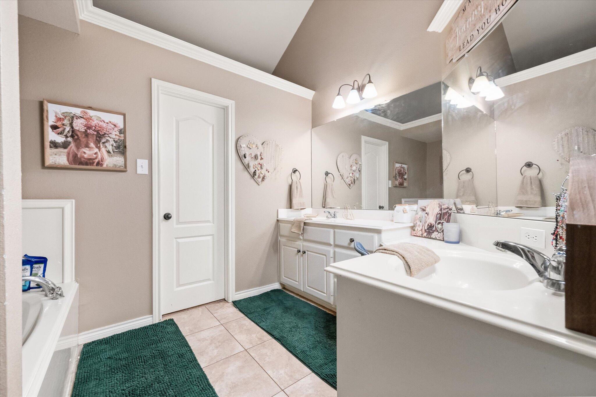 5838 101st Street Lubbock, TX 79424 - Photo 33 of 37 a bathroom with a sink vanity and a mirror