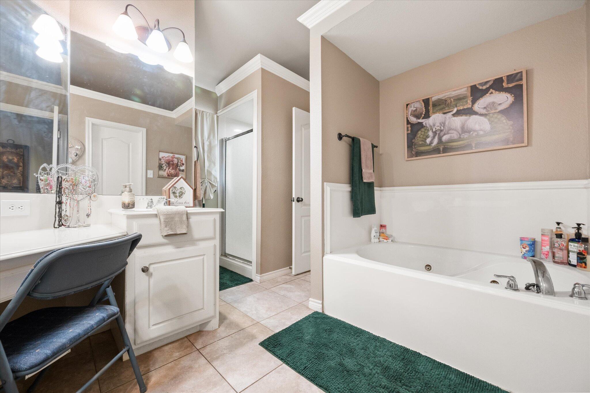 5838 101st Street Lubbock, TX 79424 - Photo 35 of 37 a bathroom with a bathtub a sink and a mirror