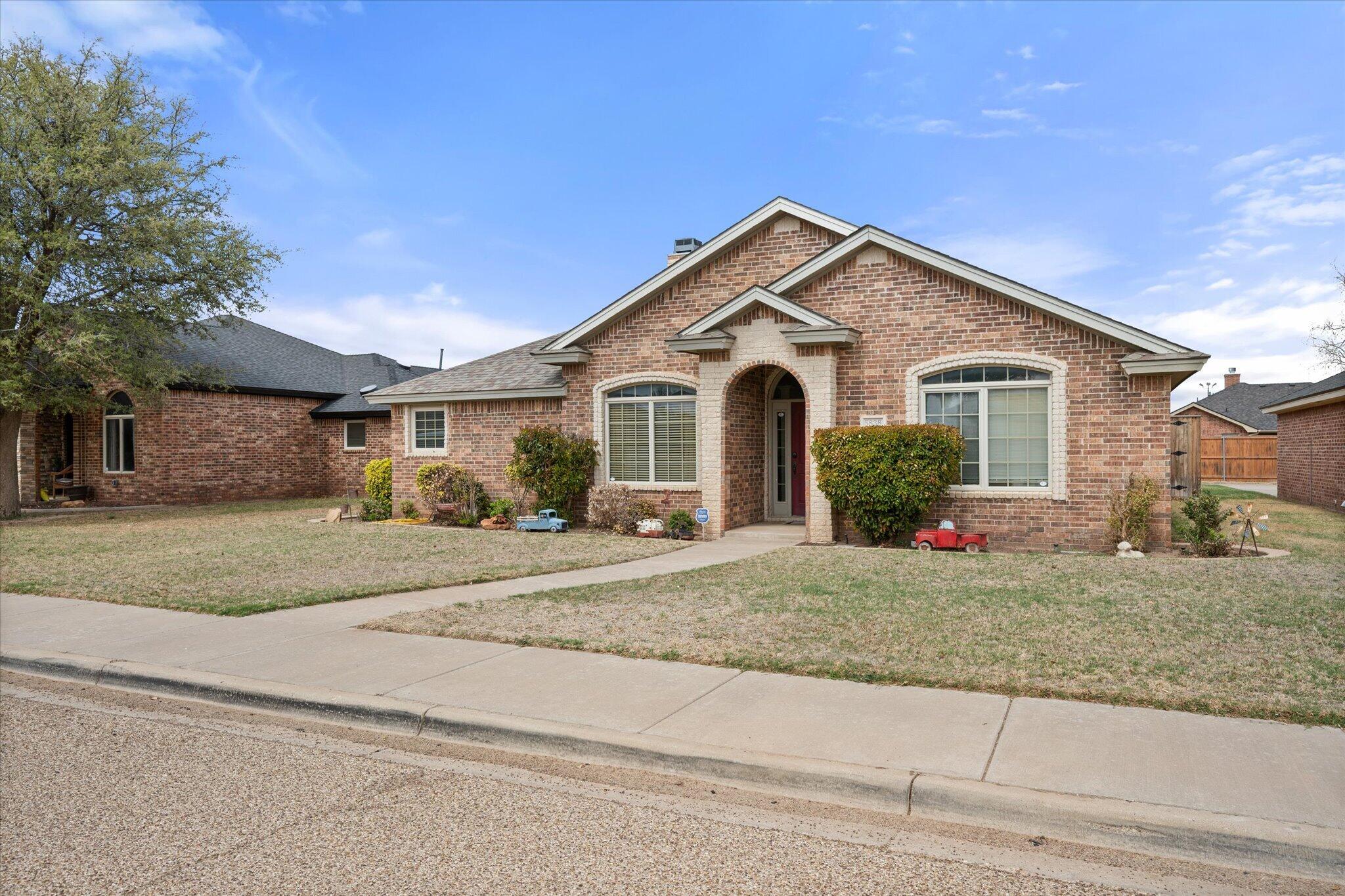 5838 101st Street Lubbock, TX 79424 - Photo 5 of 37 a front view of a house with garage and plants