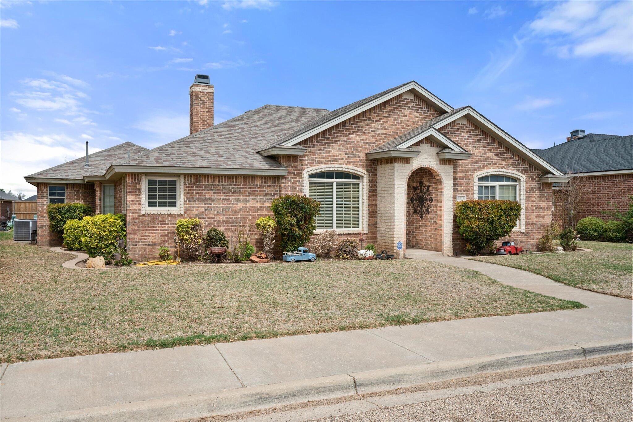5838 101st Street Lubbock, TX 79424 - Photo 7 of 37 a view of a house with a yard and potted plants