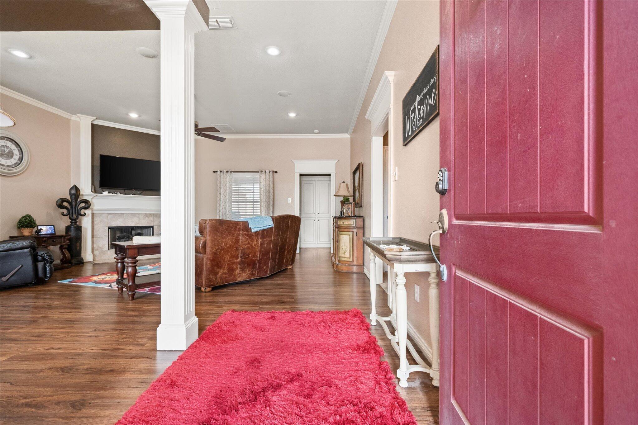 5838 101st Street Lubbock, TX 79424 - Photo 10 of 37 a living room with furniture wooden floor and a flat screen tv