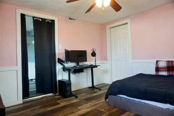 a bedroom with a bed and a flat screen tv