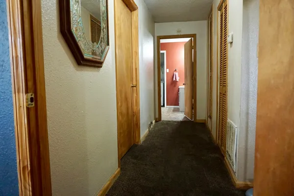 a view of a hallway with washer and dryer