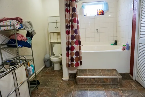 a bathroom with a bathtub and toilet