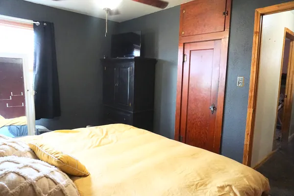 a bedroom with a bed and a chandelier