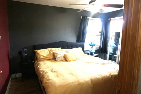 a bed sitting in a bedroom next to a window