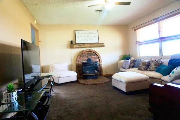 a living room with furniture a large window and a flat screen tv