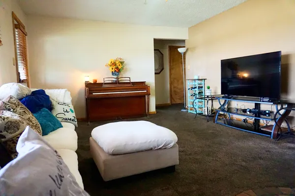 a living room with furniture and a flat screen tv