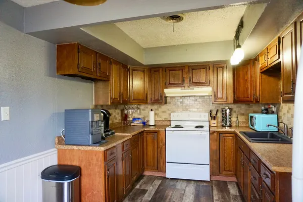a kitchen with a stove and a refrigerator