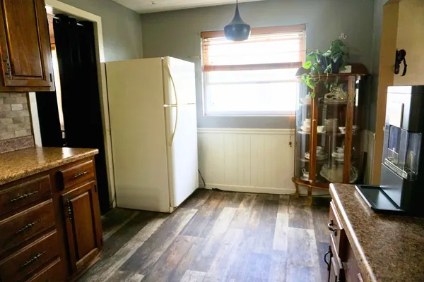a kitchen with a refrigerator and a stove