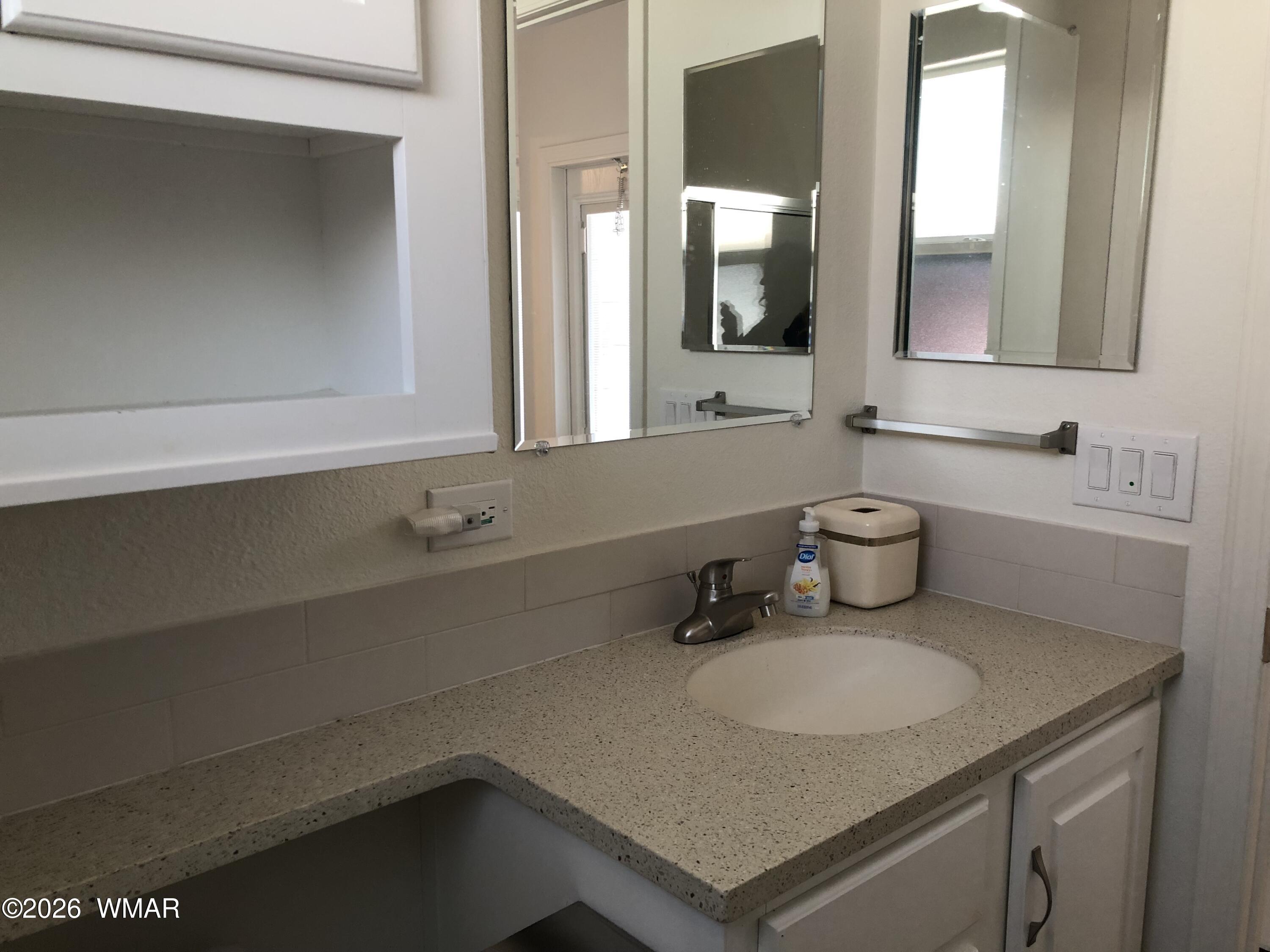 2301 Turtle Creek Road Show Low, AZ 85901 - Photo 20 of 35 a bathroom with a sink and a mirror