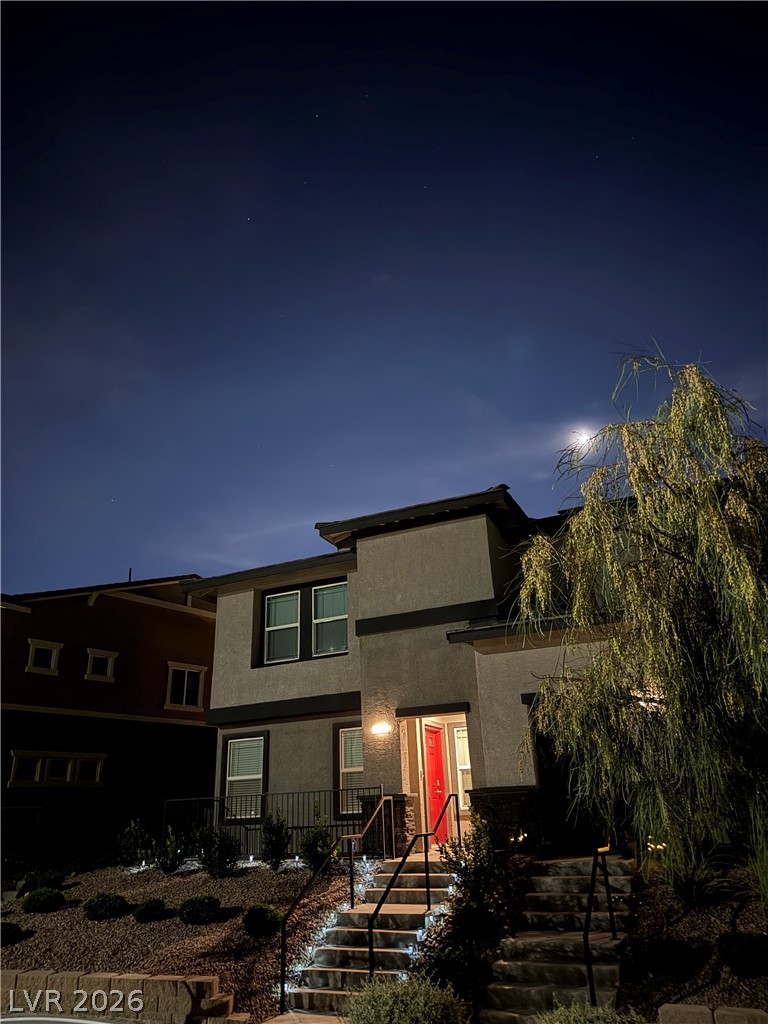 1114 Scarlet Sparrow Street Henderson, NV 89011 - Photo 24 of 25 An inviting entrance with glowing steps beckons under a moonlit sky.