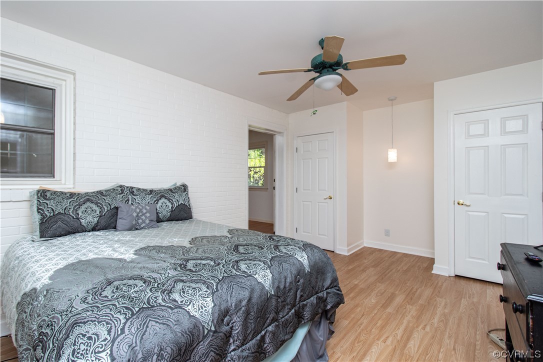 1305 Covington Road Colonial Heights, VA 23834 - Photo 19 of 34 a spacious bedroom with a bed and a chandelier