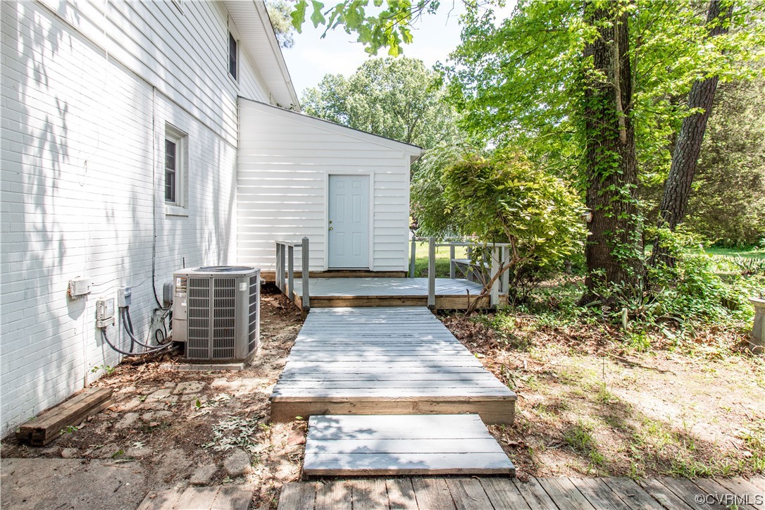 1305 Covington Road Colonial Heights, VA 23834 - Photo 20 of 34 a view of a backyard with large trees and plants