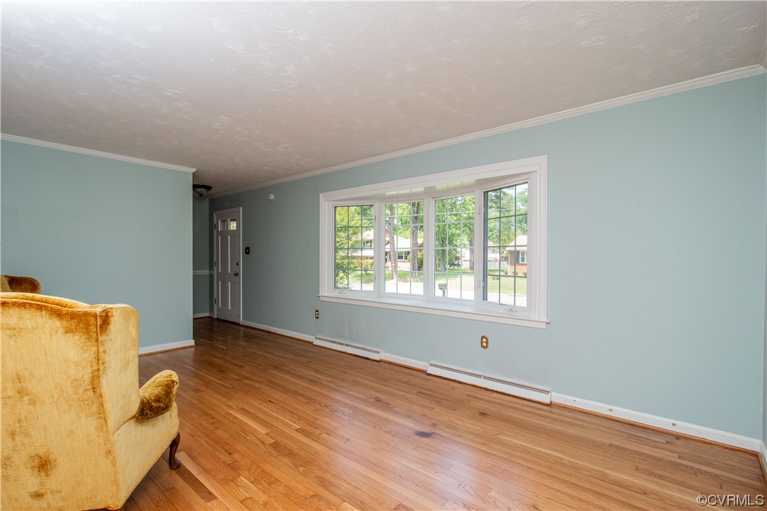 1305 Covington Road Colonial Heights, VA 23834 - Photo 4 of 34 a view of an empty room with wooden floor and a window