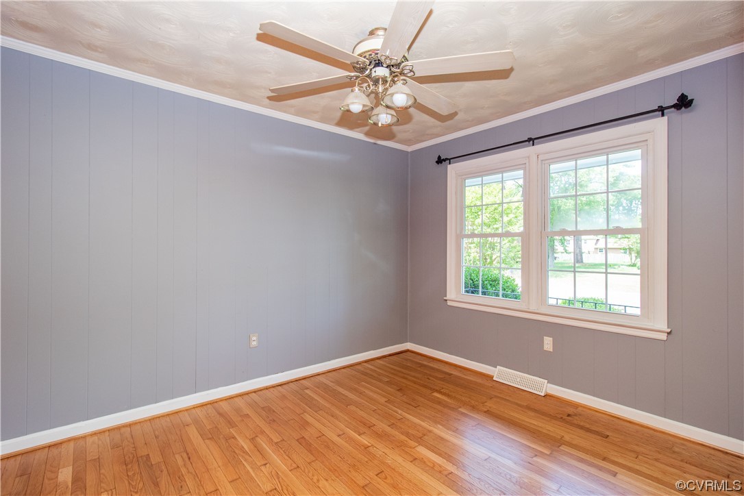 1305 Covington Road Colonial Heights, VA 23834 - Photo 7 of 34 an empty room with a window and a fan