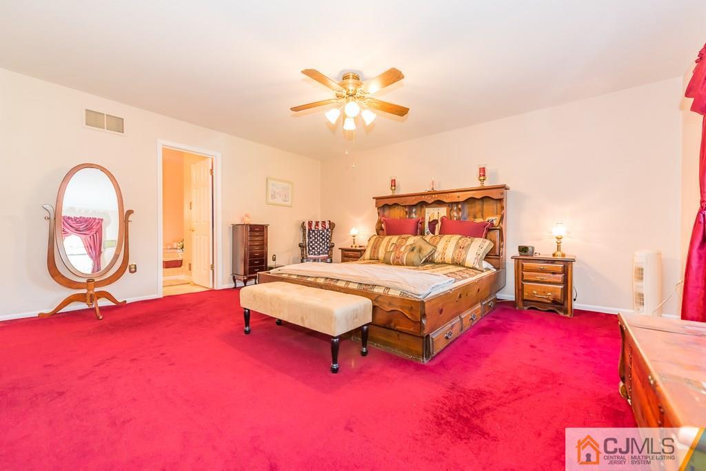 14 Crest Road Jackson, NJ 08527 - Photo 14 of 24 a bedroom with a bed and a chandelier