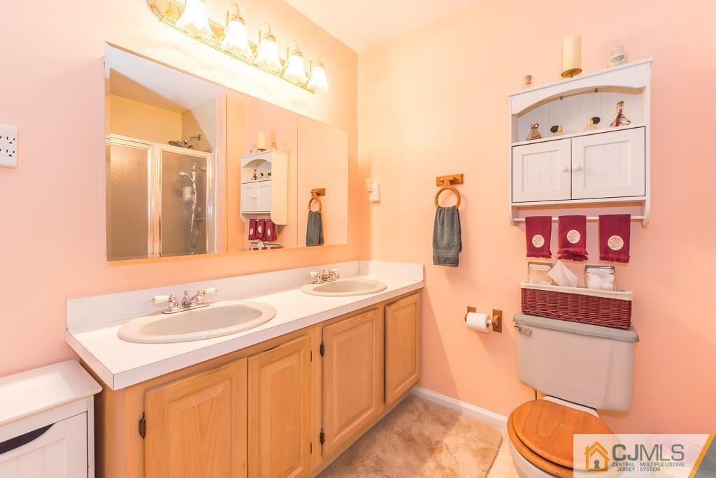 14 Crest Road Jackson, NJ 08527 - Photo 17 of 24 a bathroom with a sink vanity mirror and toilet