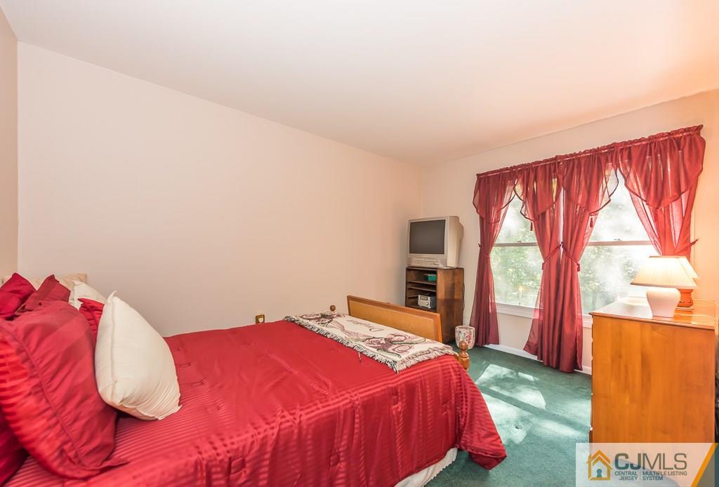 14 Crest Road Jackson, NJ 08527 - Photo 18 of 24 a bed sitting in a bedroom next to a window