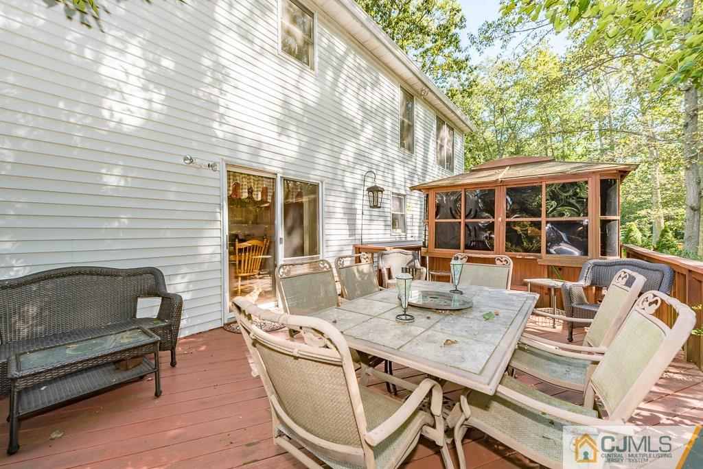 14 Crest Road Jackson, NJ 08527 - Photo 21 of 24 a view of a patio with couches table and chairs and potted plants