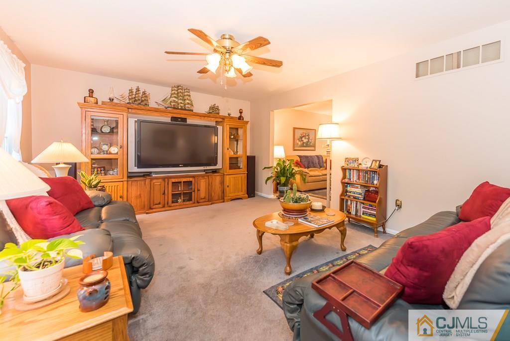 14 Crest Road Jackson, NJ 08527 - Photo 7 of 24 a living room with furniture and a flat screen tv