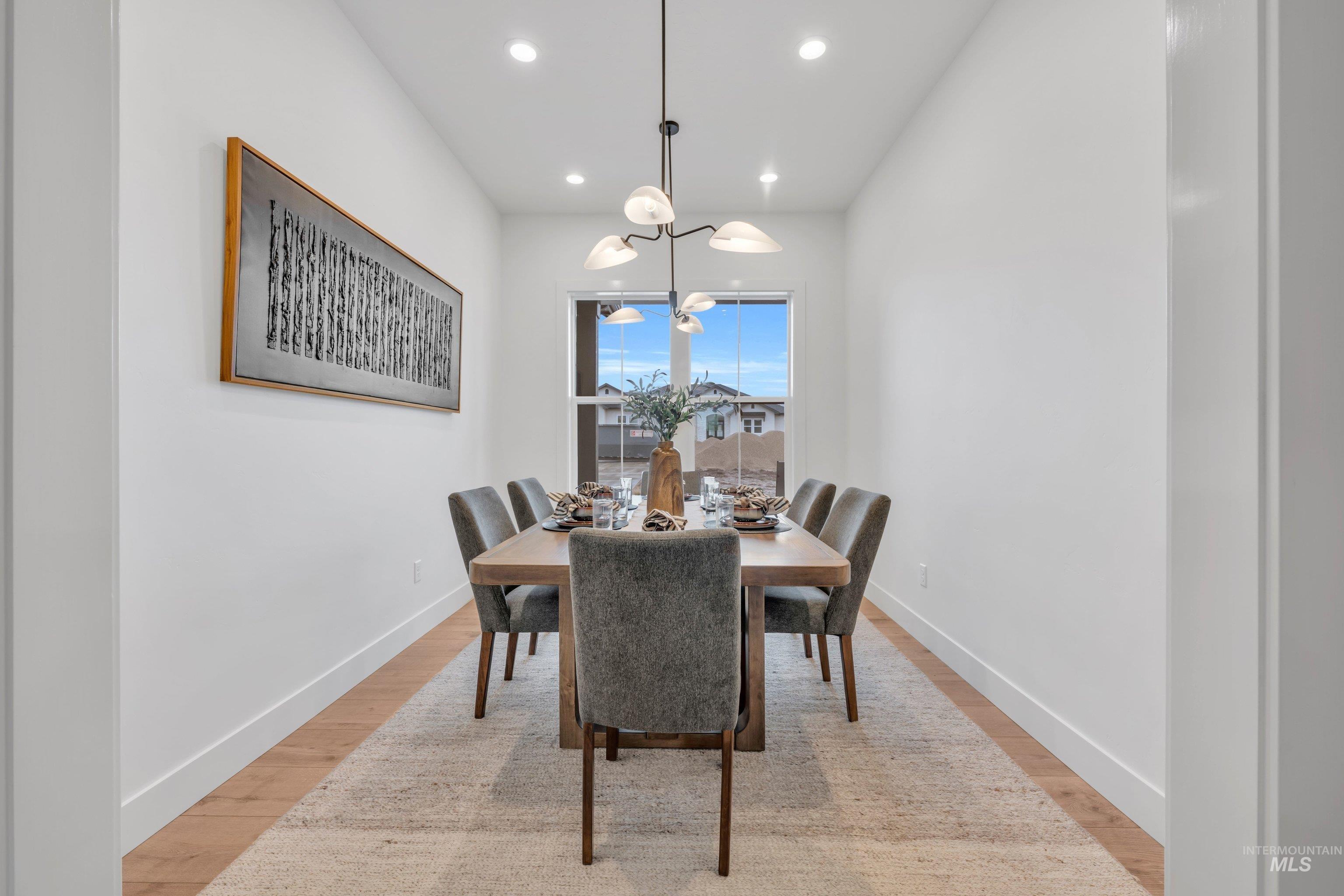 24871 Ardmore Court Caldwell, ID 83607 - Photo 18 of 44 Dining room with light wood-type flooring and suspended lighting