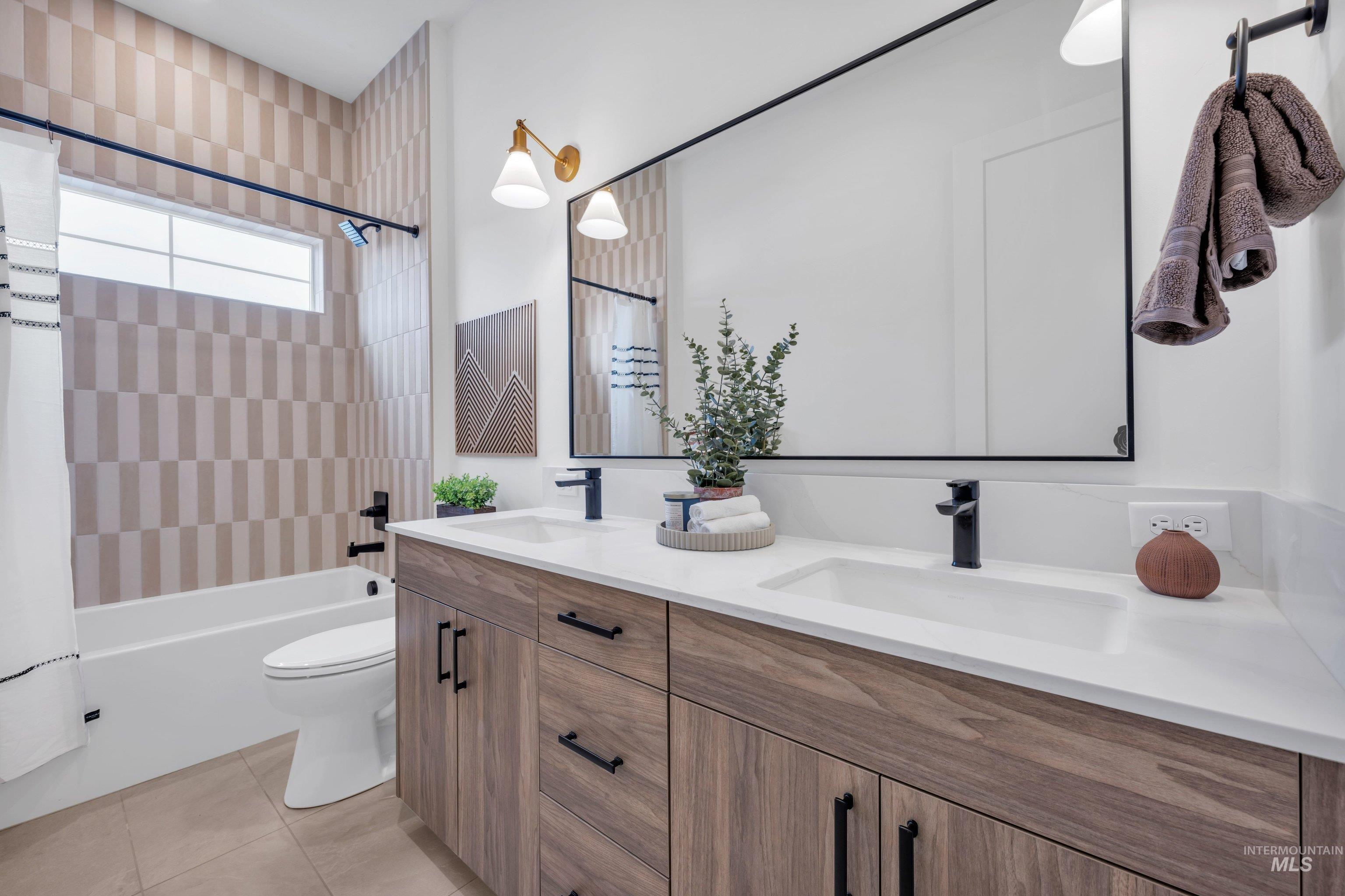 24871 Ardmore Court Caldwell, ID 83607 - Photo 25 of 44 Bathroom with double vanity, shower / bath combination with curtain, and light tile patterned floors