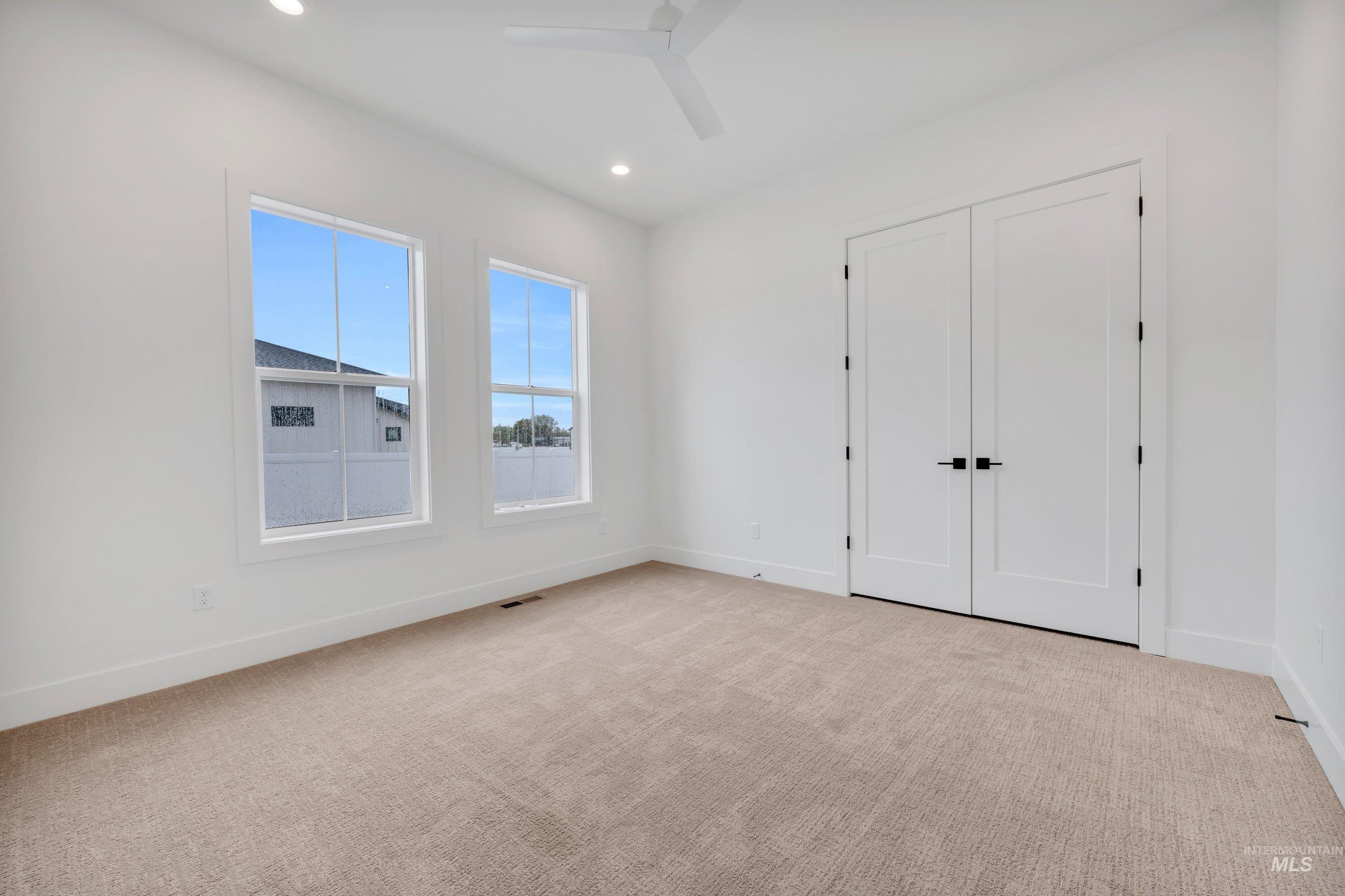 24871 Ardmore Court Caldwell, ID 83607 - Photo 26 of 44 Unfurnished bedroom with light carpet, recessed lighting, a ceiling fan, and a closet