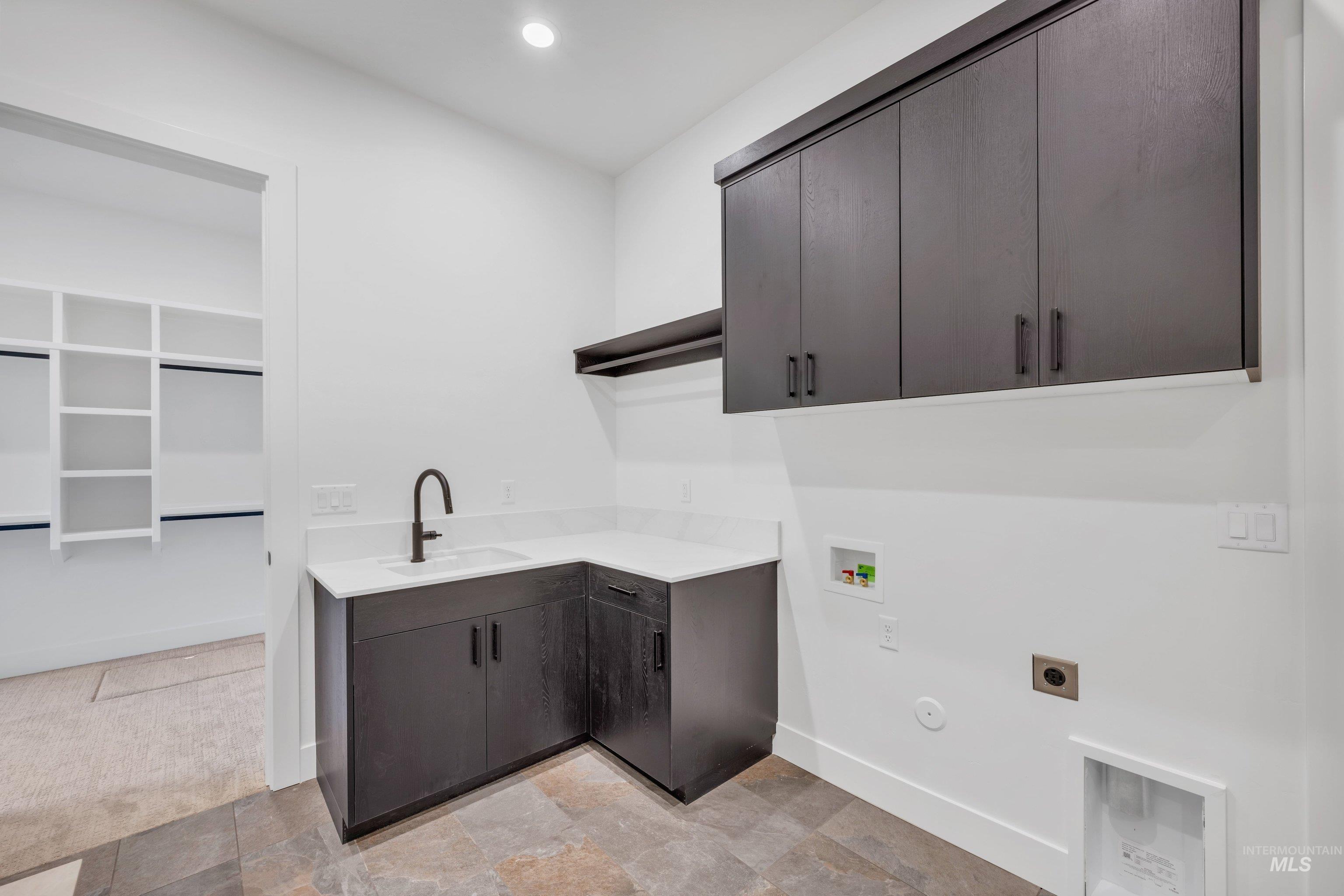 24871 Ardmore Court Caldwell, ID 83607 - Photo 29 of 44 Laundry room featuring washer hookup, cabinet space, stone finish flooring, hookup for an electric dryer, and recessed lighting