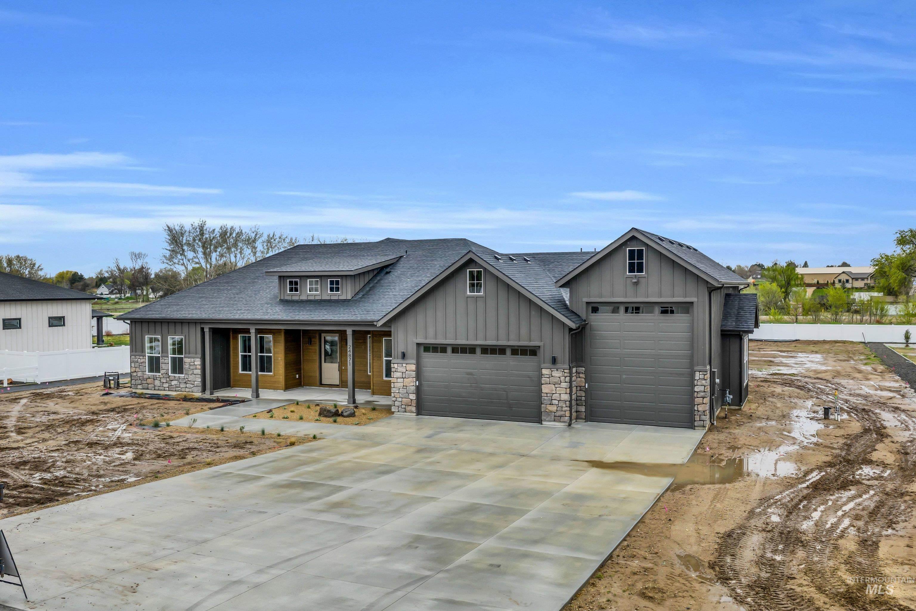 24871 Ardmore Court Caldwell, ID 83607 - Photo 33 of 44 Craftsman house with a porch, board and batten siding, concrete driveway, an attached garage, and stone siding