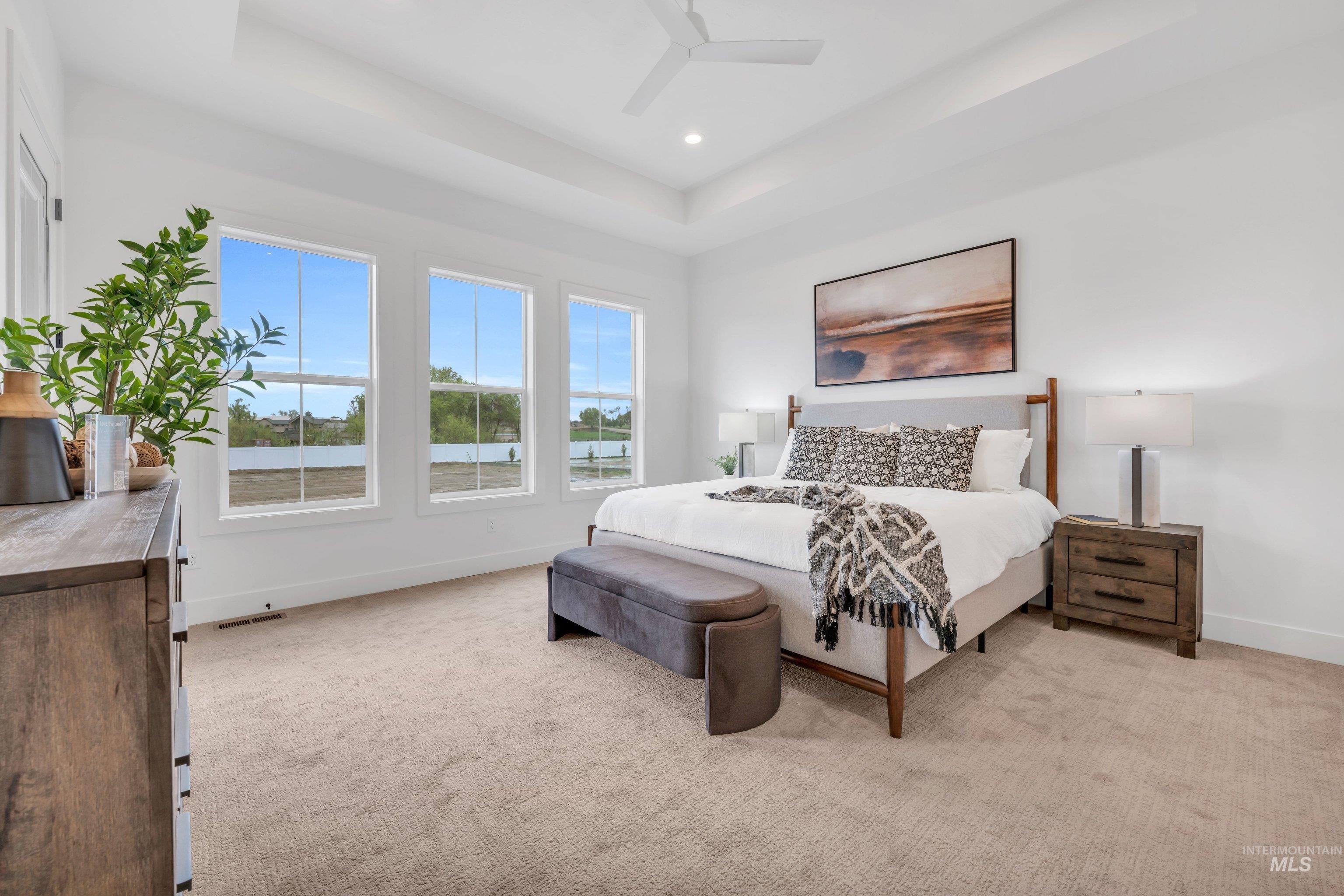 24871 Ardmore Court Caldwell, ID 83607 - Photo 36 of 44 Bedroom with light carpet, a raised ceiling, a ceiling fan, and recessed lighting