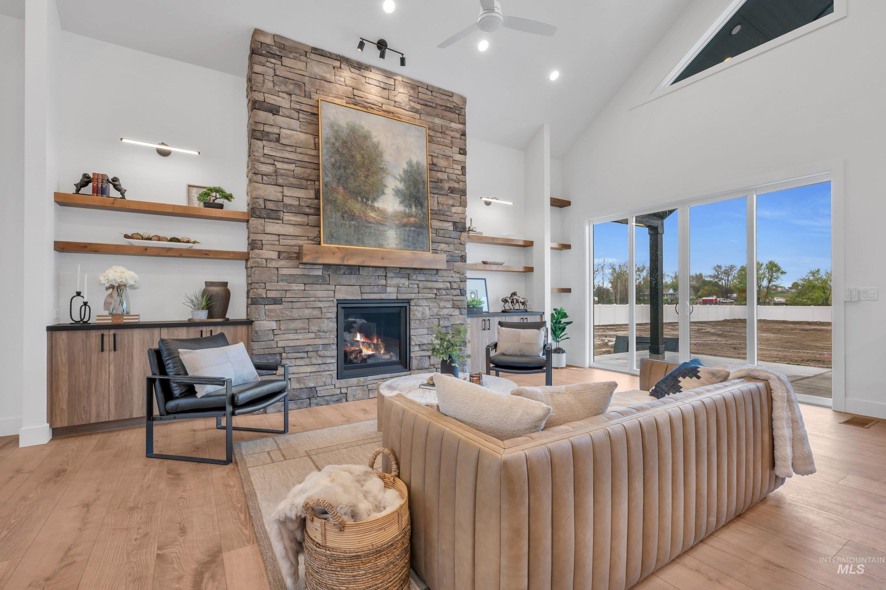 24871 Ardmore Court Caldwell, ID 83607 - Photo 6 of 44 Living room featuring light wood-style floors, a fireplace, ceiling fan, vaulted ceiling, and recessed lighting