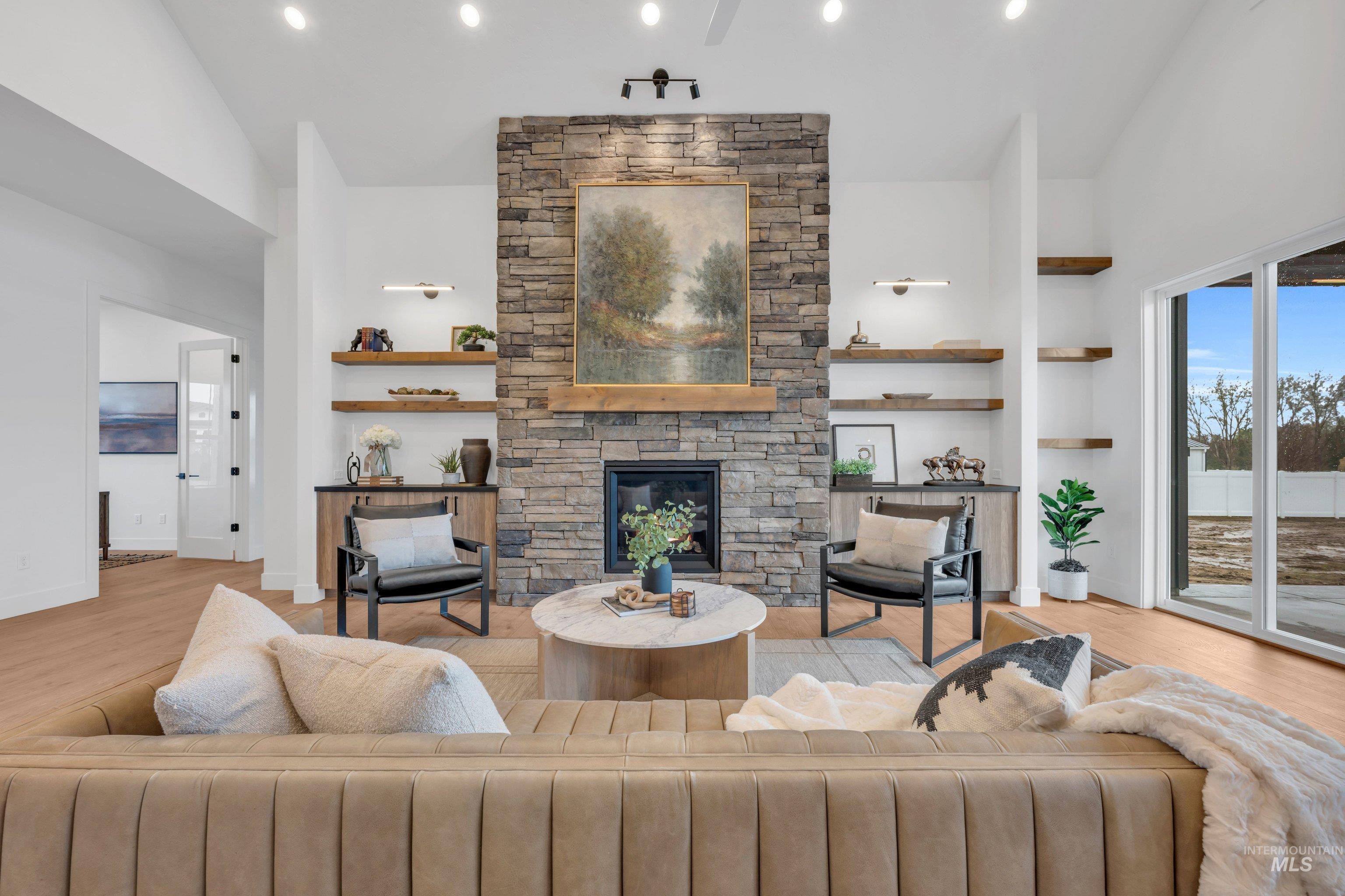24871 Ardmore Court Caldwell, ID 83607 - Photo 7 of 44 Living area featuring light wood-style flooring, lofted ceiling, and a fireplace