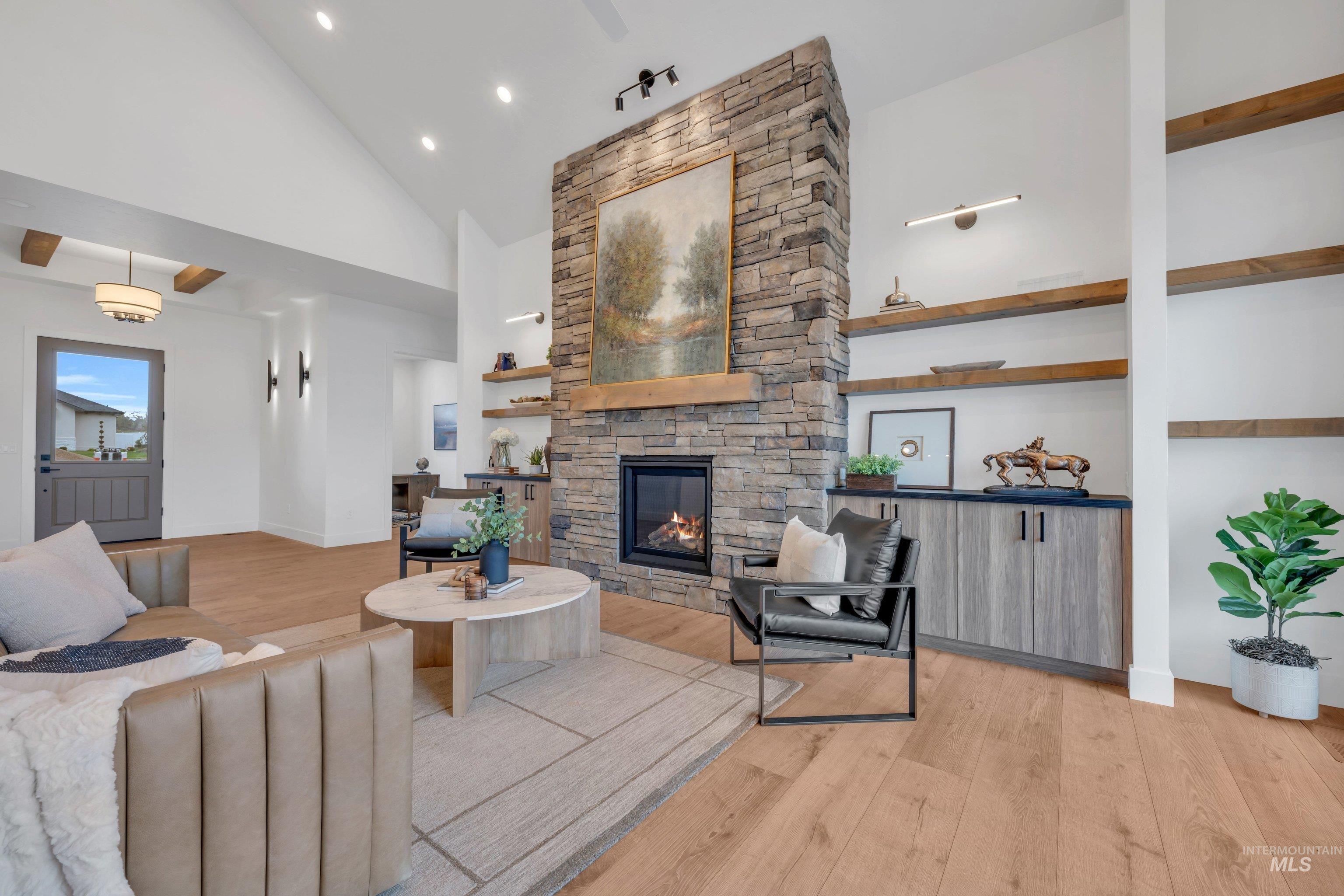 24871 Ardmore Court Caldwell, ID 83607 - Photo 8 of 44 Living area featuring light wood finished floors, vaulted ceiling, a fireplace, and recessed lighting