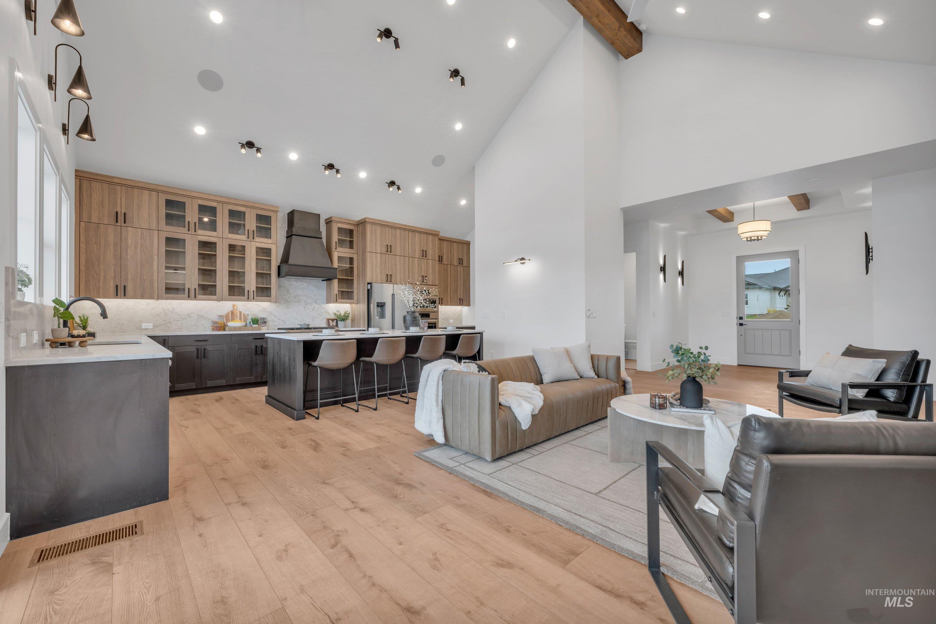 24871 Ardmore Court Caldwell, ID 83607 - Photo 9 of 44 Living area with light wood-type flooring, recessed lighting, and lofted ceiling