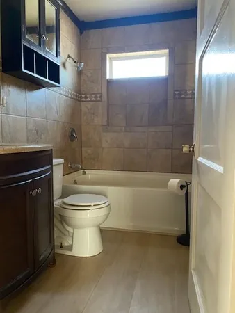 a bathroom with a toilet a sink and bathtub