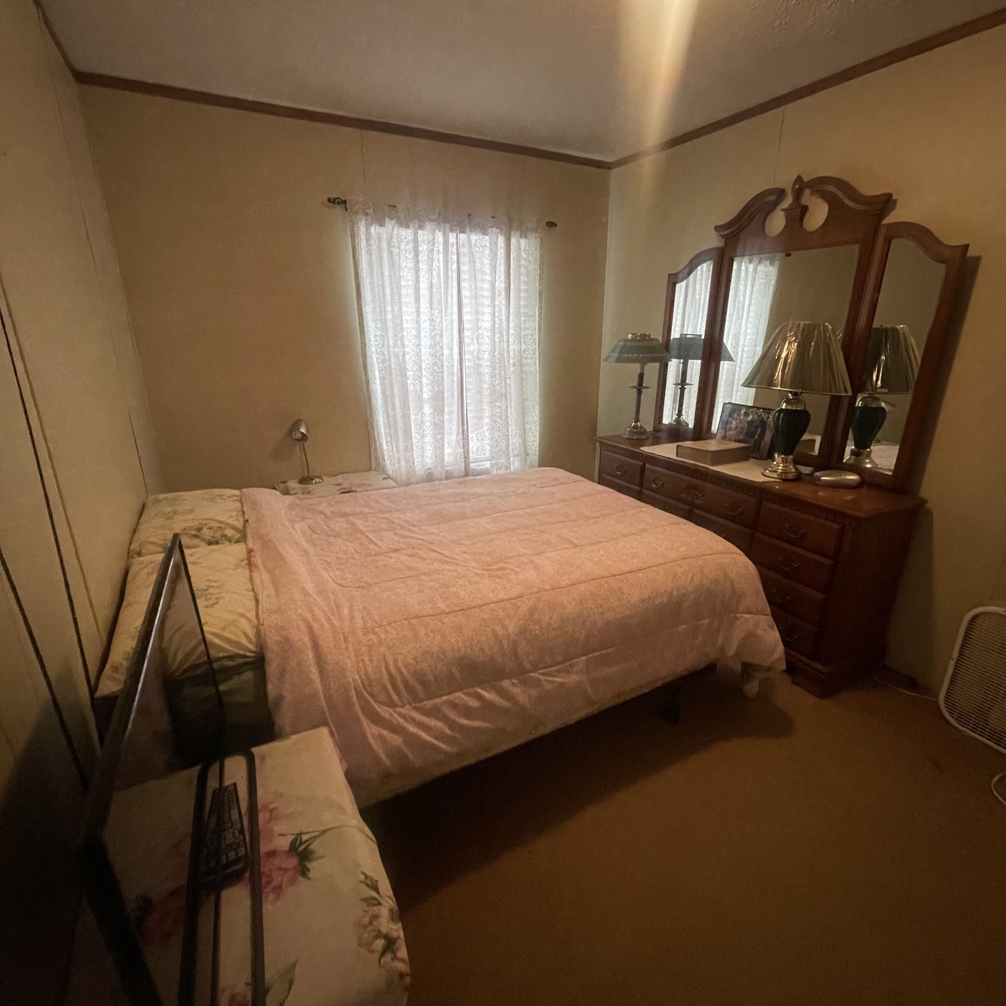 75 Snell Road Ethridge, TN 38456 - Photo 19 of 51 a bedroom with a bed a mirror on dresser and a window